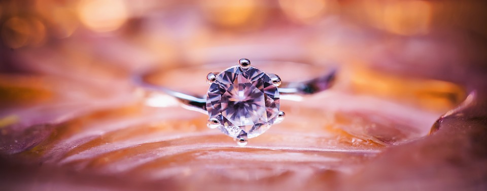 diamond ring on pink orange background
